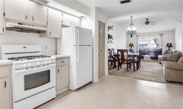 a view of kitchen with furniture and stainless steel appliances