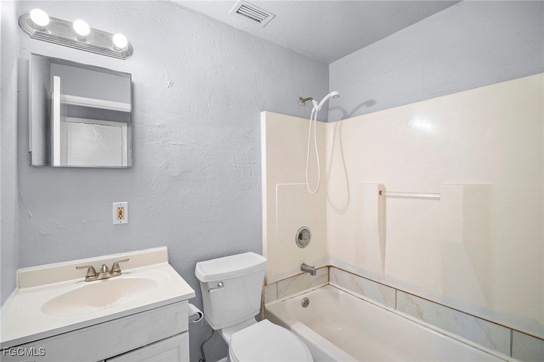 5449 Tenth Avenue Fort Myers, FL 33907 - Photo 15 of 18 a bathroom with a sink toilet and shower
