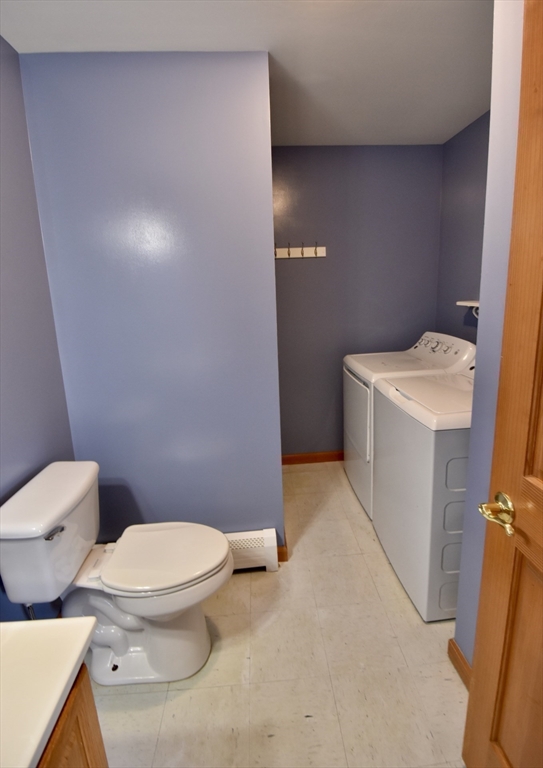 375 Thompson Road Webster, MA 01570 - Photo 15 of 21 a white toilet sitting next to a white sink and vanity