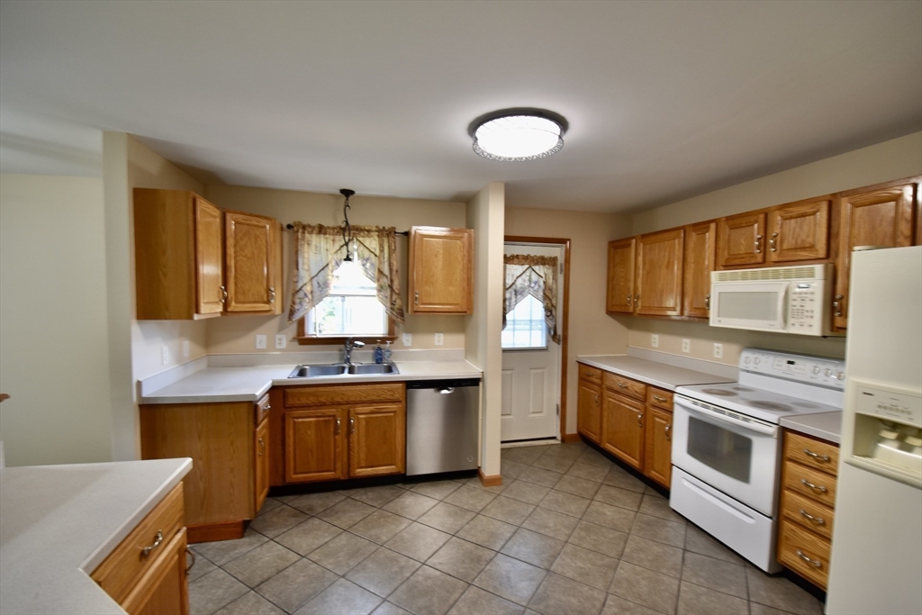 375 Thompson Road Webster, MA 01570 - Photo 4 of 21 a kitchen with stainless steel appliances granite countertop a stove top oven