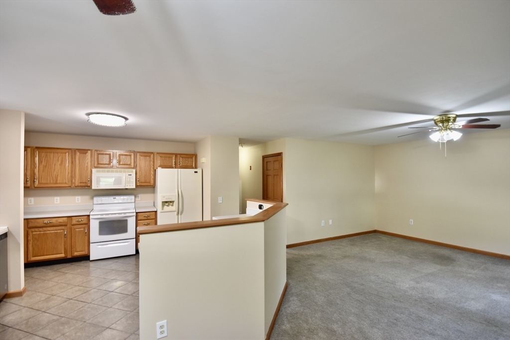 375 Thompson Road Webster, MA 01570 - Photo 6 of 21 wooden floor in an empty room with a kitchen