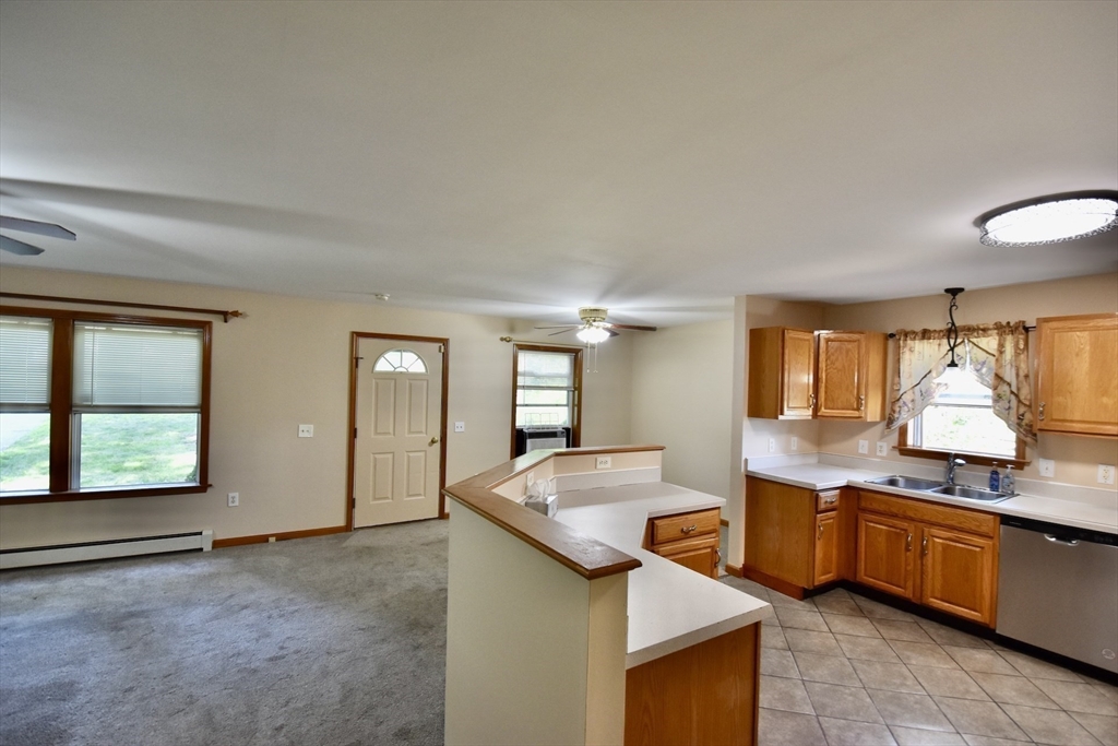 375 Thompson Road Webster, MA 01570 - Photo 7 of 21 a kitchen with stainless steel appliances granite countertop a sink and a stove