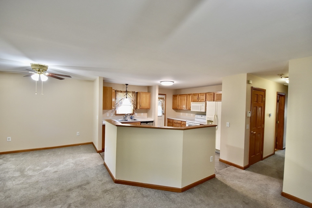 375 Thompson Road Webster, MA 01570 - Photo 8 of 21 a view of a kitchen with kitchen island a stove a sink and a refrigerator