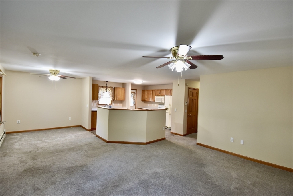 375 Thompson Road Webster, MA 01570 - Photo 9 of 21 an empty room with ceiling fan and window
