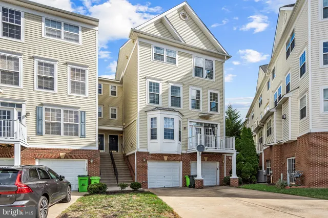 a front view of a residential apartment building with a yard