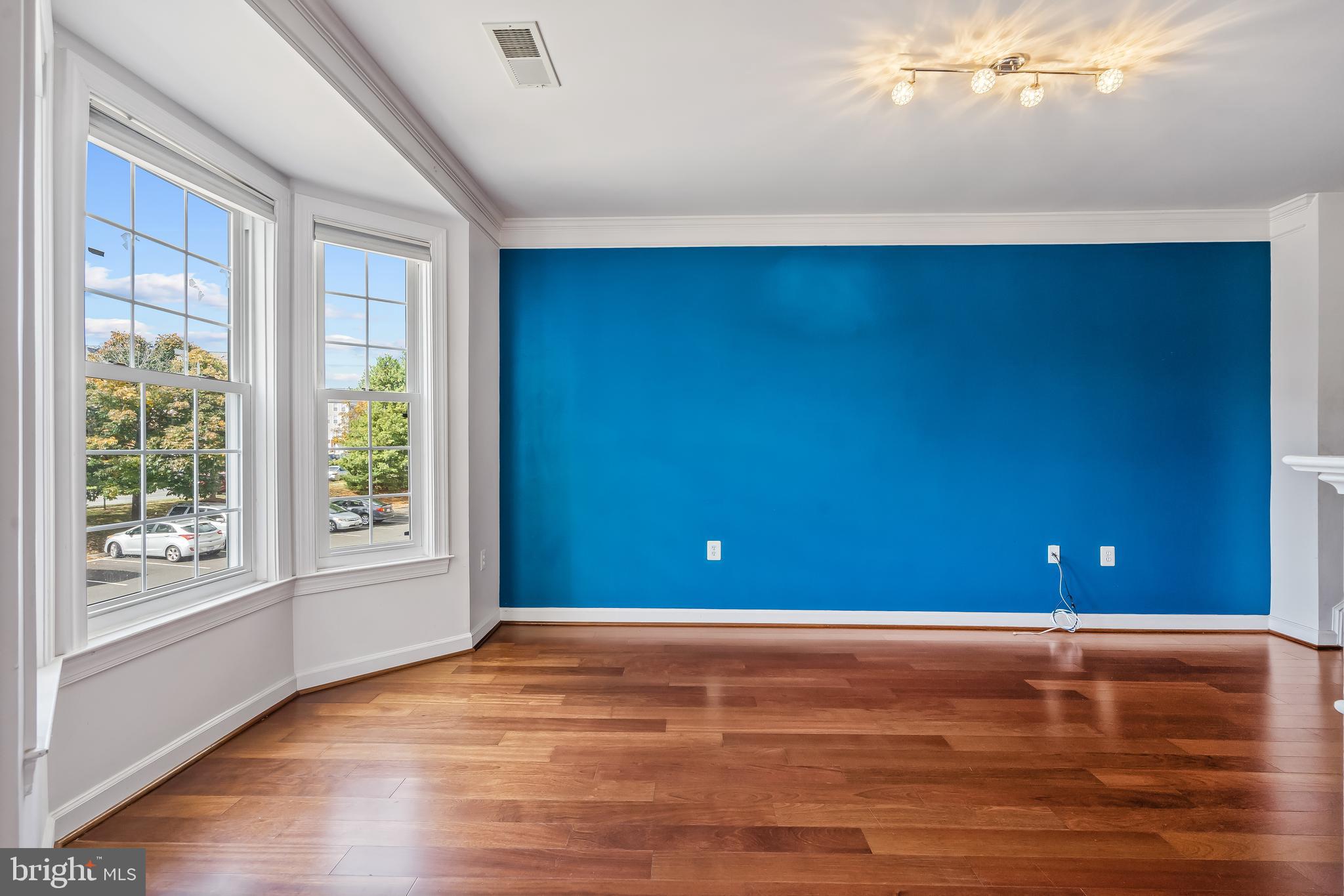 13600 Salk Street, Unit 131 Herndon, VA 20171 - Photo 12 of 34 a view of an empty room with window and wooden floor