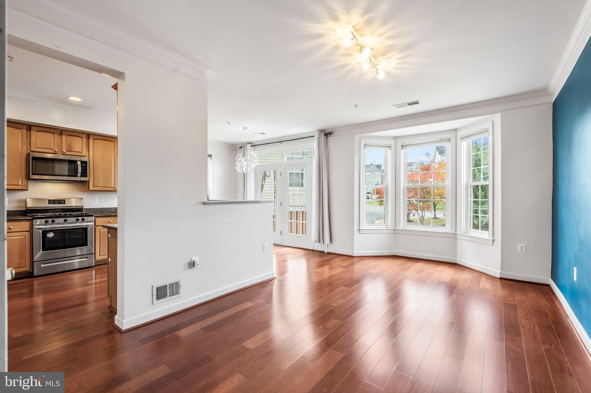 13600 Salk Street, Unit 131 Herndon, VA 20171 - Photo 14 of 34 a view of an empty room with kitchen and a window
