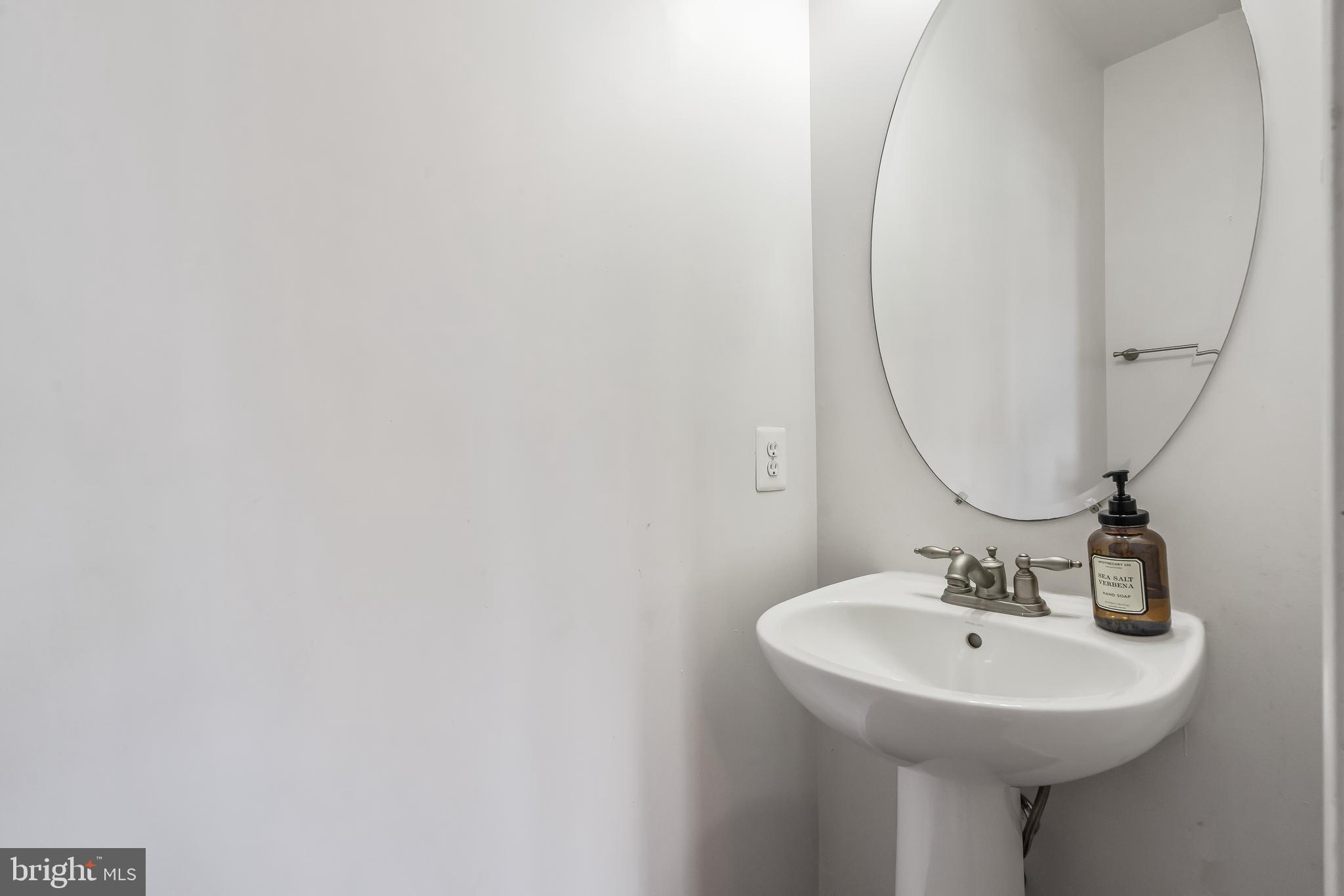 13600 Salk Street, Unit 131 Herndon, VA 20171 - Photo 16 of 34 a bathroom with a sink and a mirror