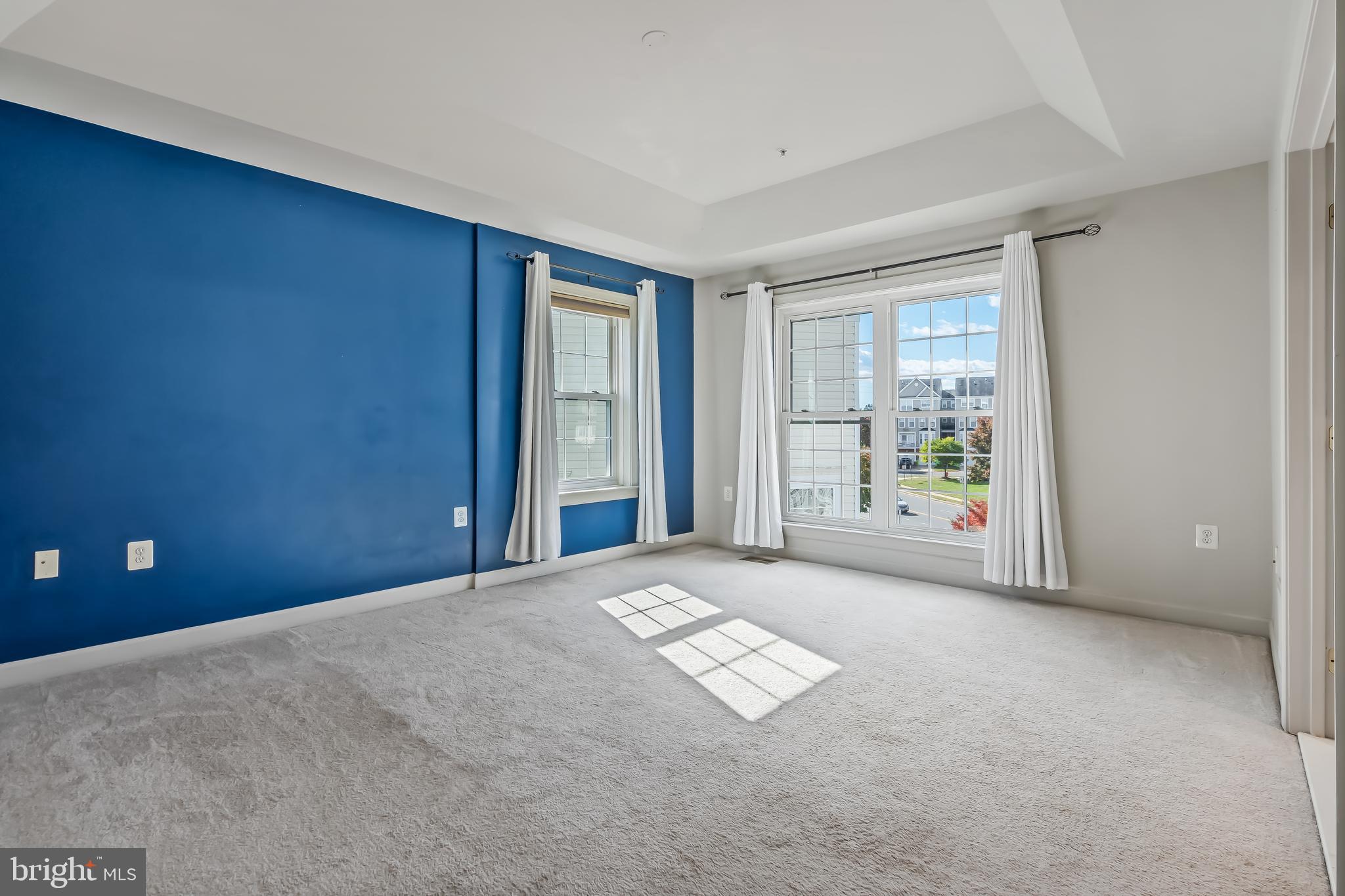 13600 Salk Street, Unit 131 Herndon, VA 20171 - Photo 19 of 34 a view of an empty room with windows