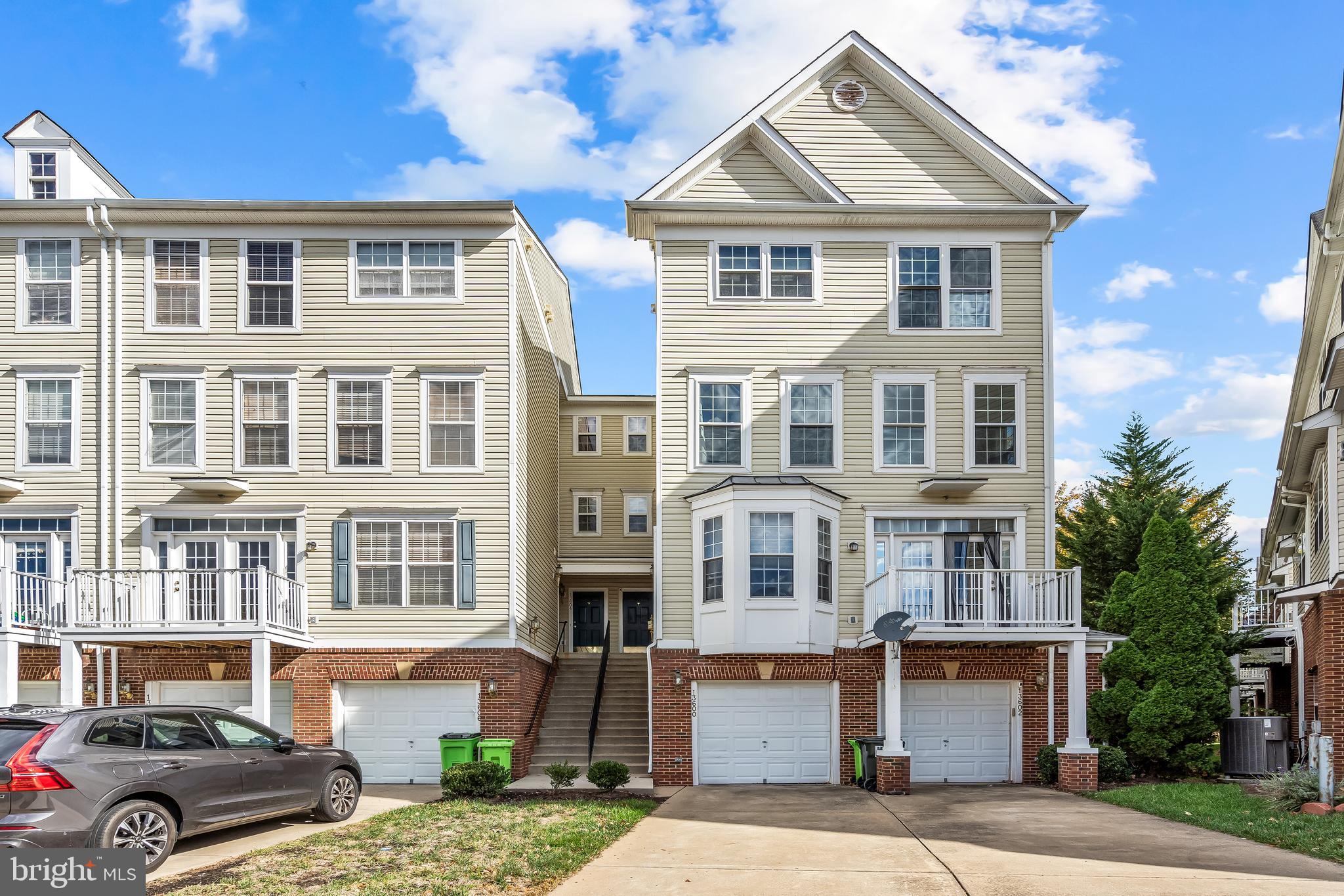 13600 Salk Street, Unit 131 Herndon, VA 20171 - Photo 2 of 34 a front view of a residential apartment building with a yard