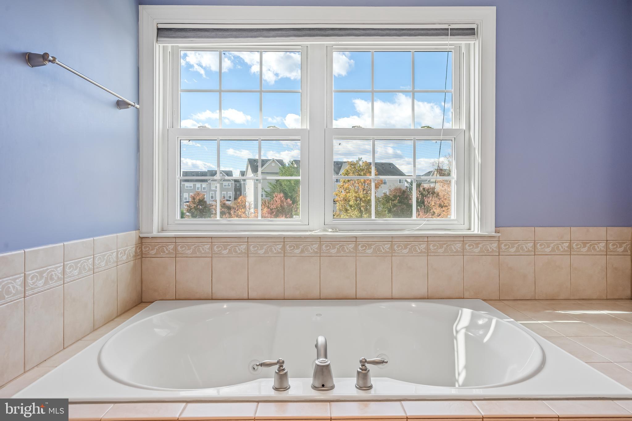 13600 Salk Street, Unit 131 Herndon, VA 20171 - Photo 26 of 34 a white bath tub sitting in a bathroom next to a window