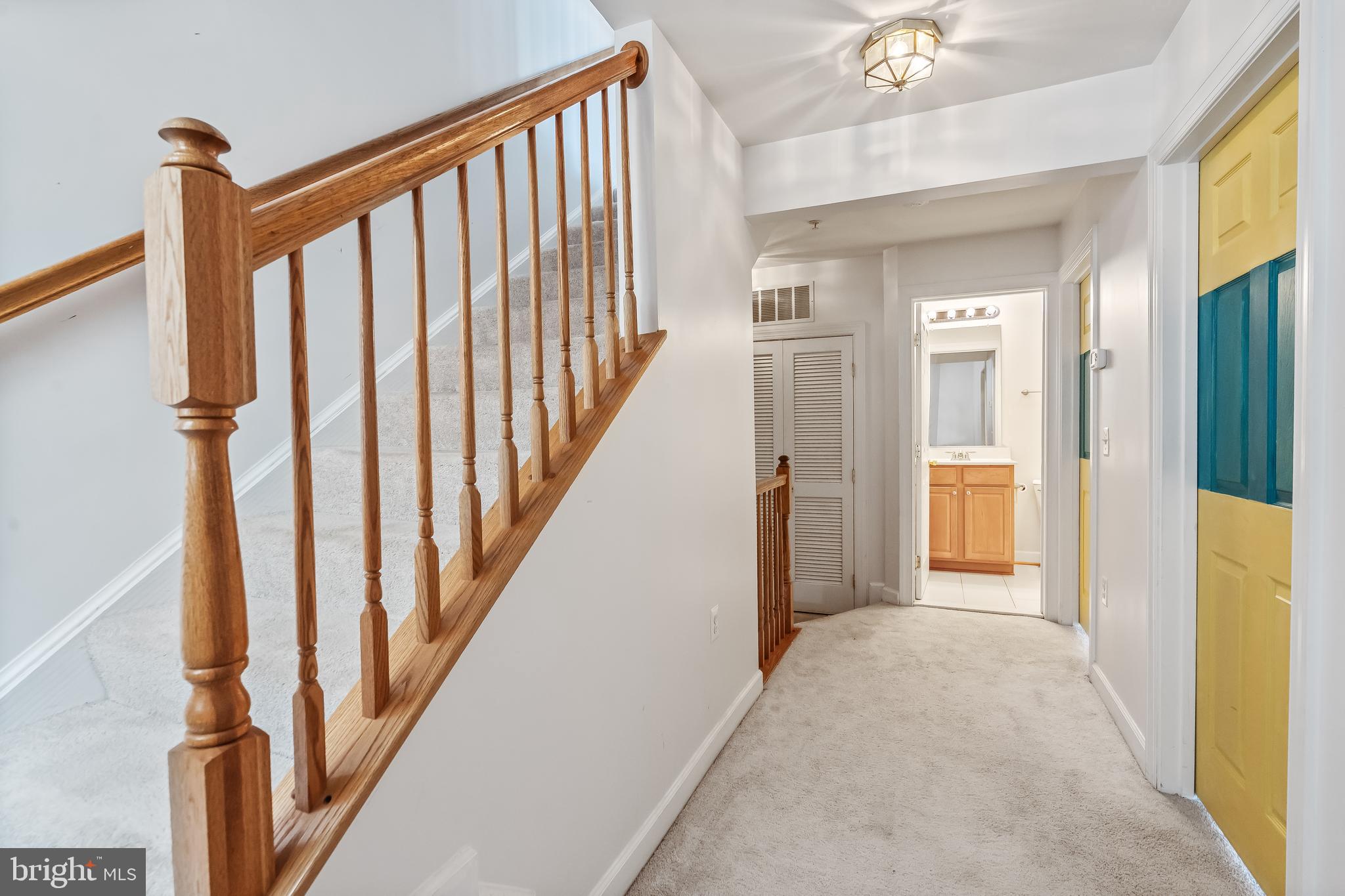 13600 Salk Street, Unit 131 Herndon, VA 20171 - Photo 28 of 34 a view of a hallway with wooden floor and staircase