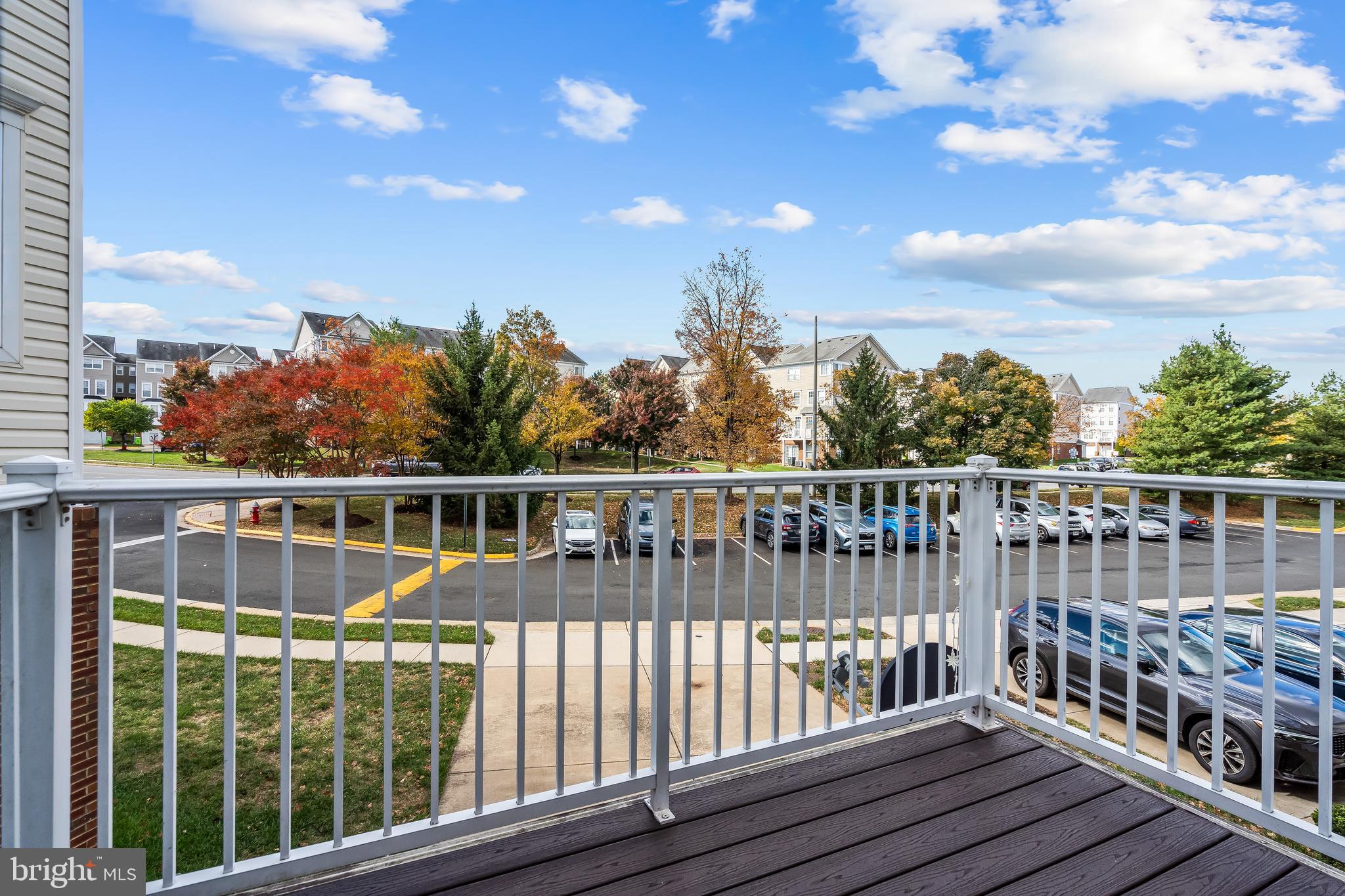13600 Salk Street, Unit 131 Herndon, VA 20171 - Photo 33 of 34 a view of a balcony with wooden floor & fence