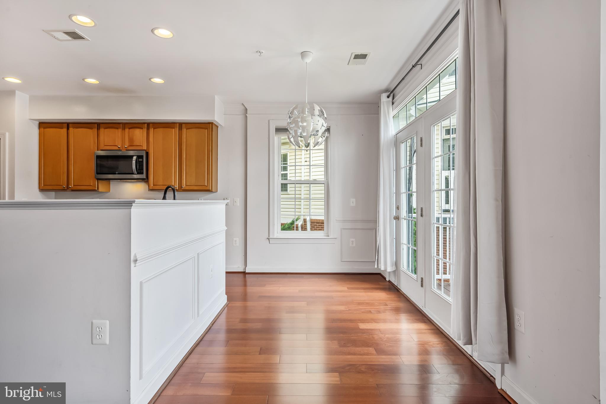 13600 Salk Street, Unit 131 Herndon, VA 20171 - Photo 9 of 34 a view of a hallway with wooden floor and a window