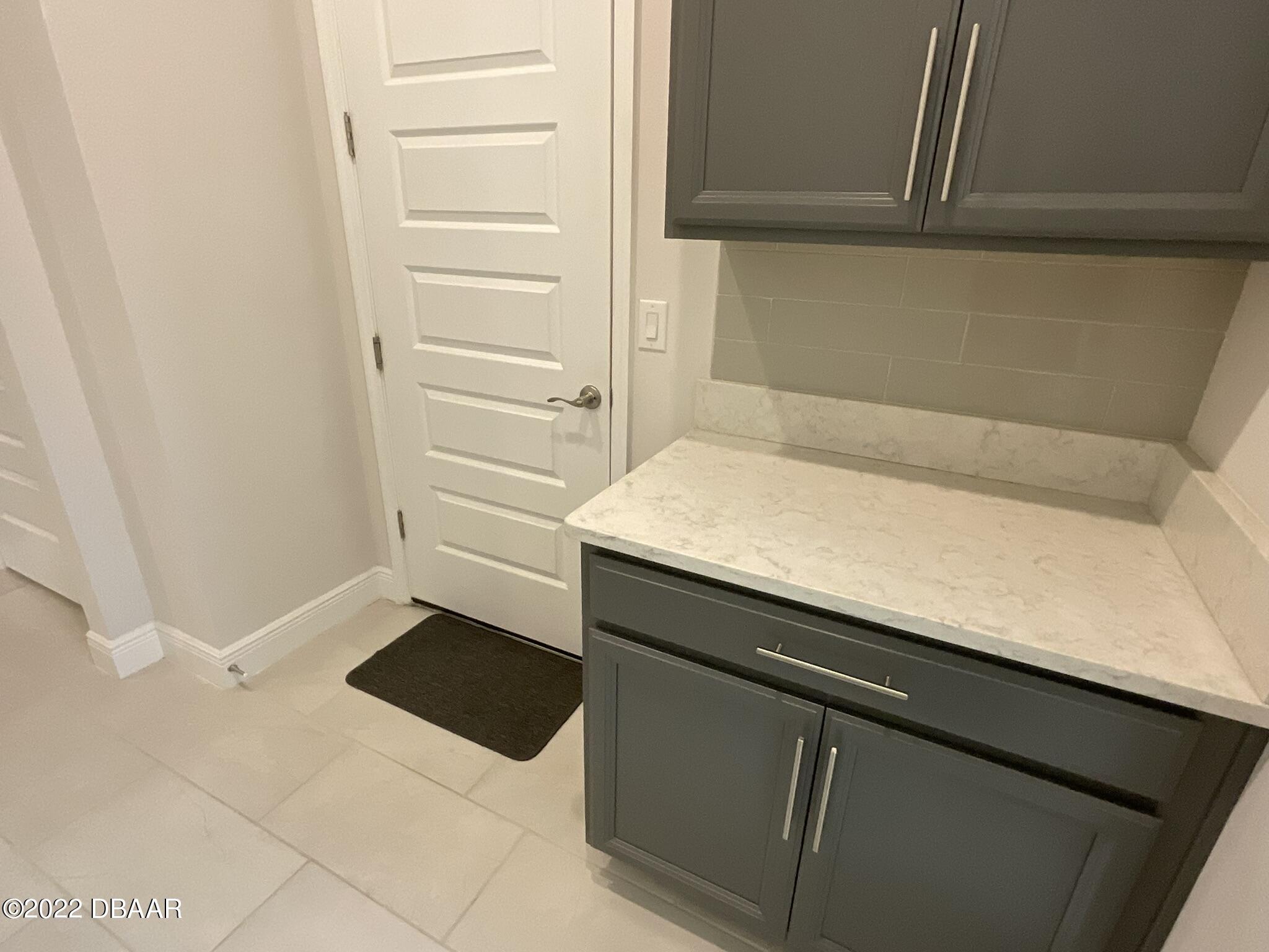 283 Cypress Trail Drive Ormond Beach, FL 32174 - Photo 17 of 28 a bathroom with a sink and a washing machine