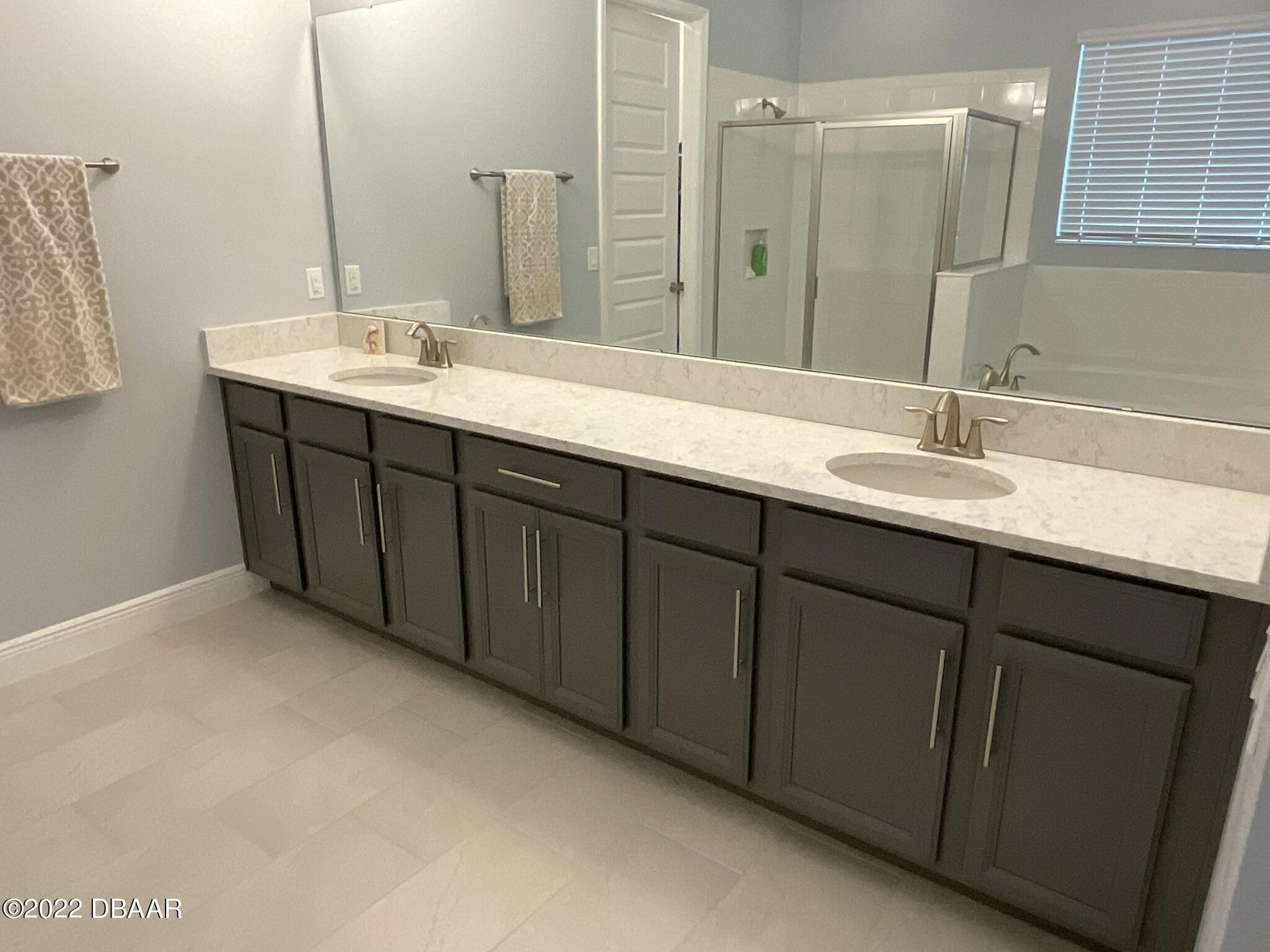 283 Cypress Trail Drive Ormond Beach, FL 32174 - Photo 7 of 28 a bathroom with a double vanity sink and mirror