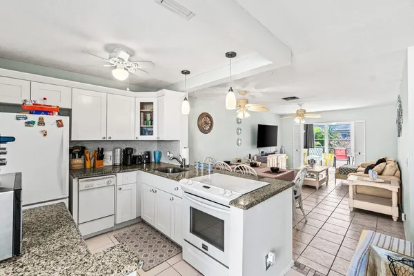 a kitchen with a sink stove and refrigerator