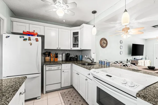 a kitchen with a sink appliances and cabinets