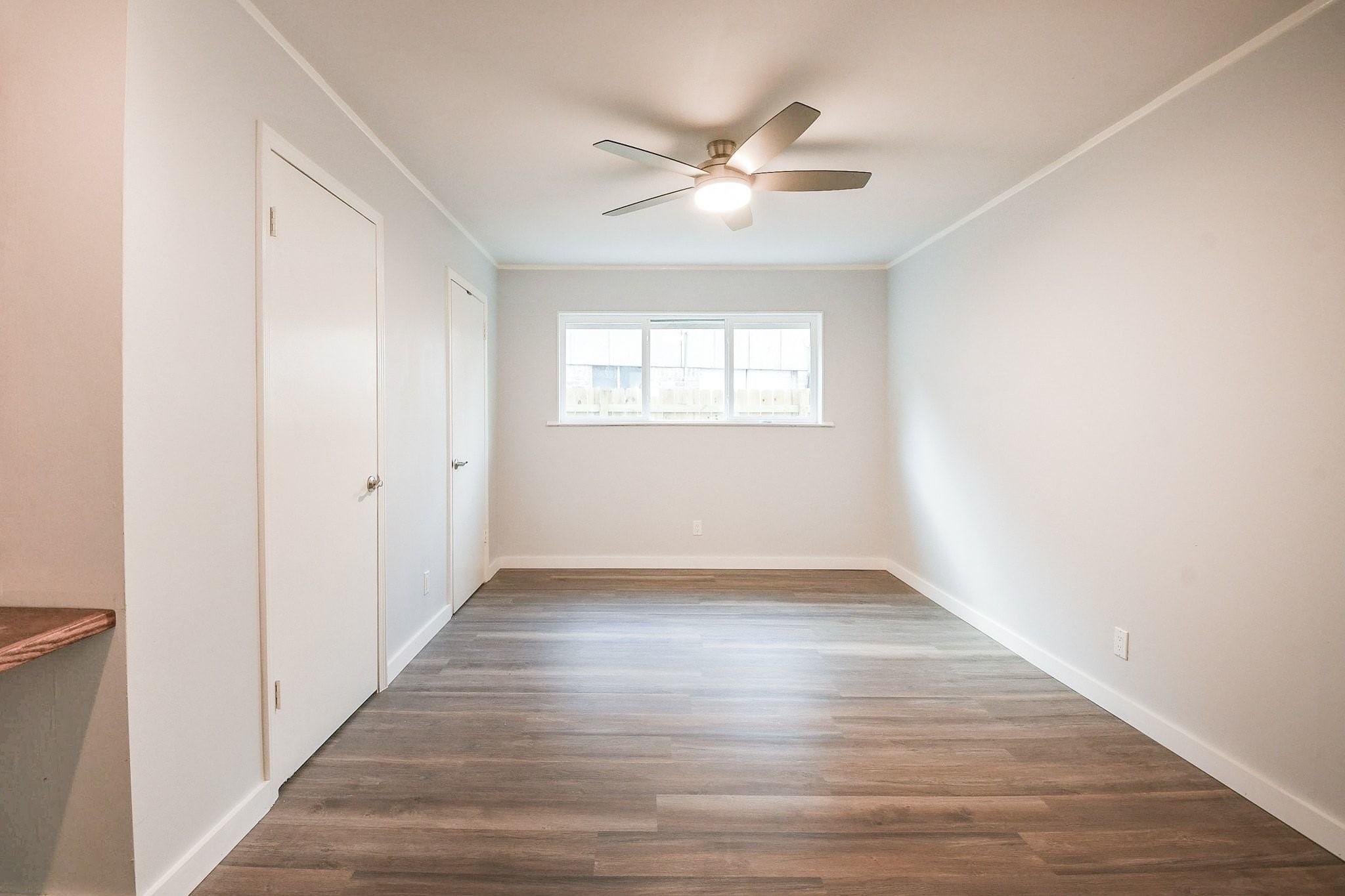 9111 Rentur Drive Houston, TX 77031 - Photo 13 of 21 a view of an empty room with wooden floor and a window