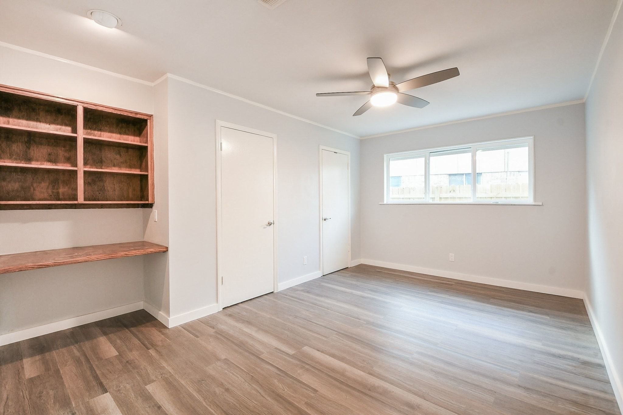 9111 Rentur Drive Houston, TX 77031 - Photo 14 of 21 an empty room with wooden floor closet and windows