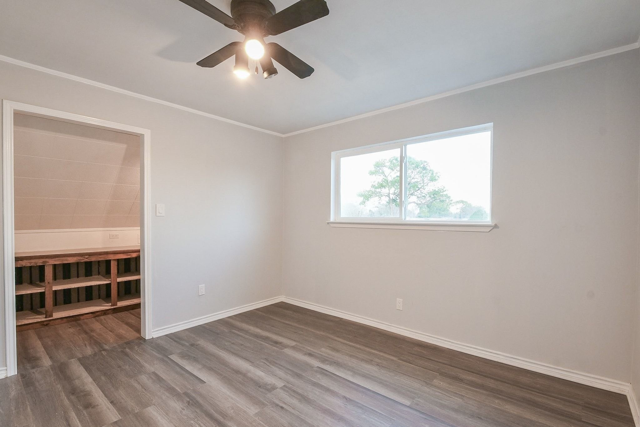 9111 Rentur Drive Houston, TX 77031 - Photo 16 of 21 an empty room with wooden floor closet and windows
