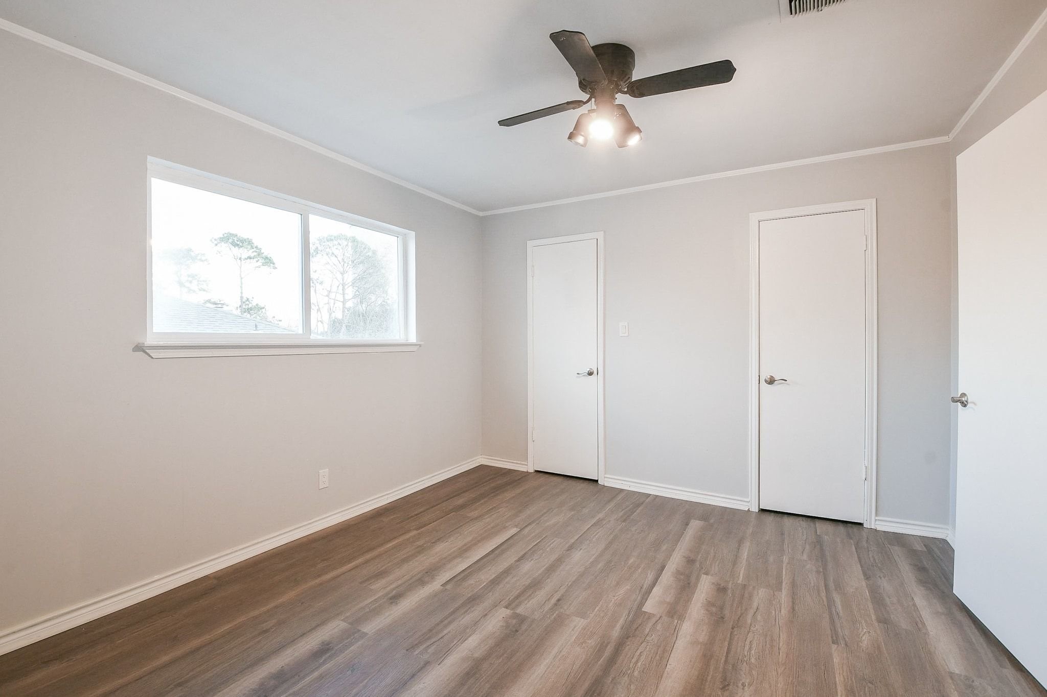 9111 Rentur Drive Houston, TX 77031 - Photo 17 of 21 wooden floor in an empty room with a window