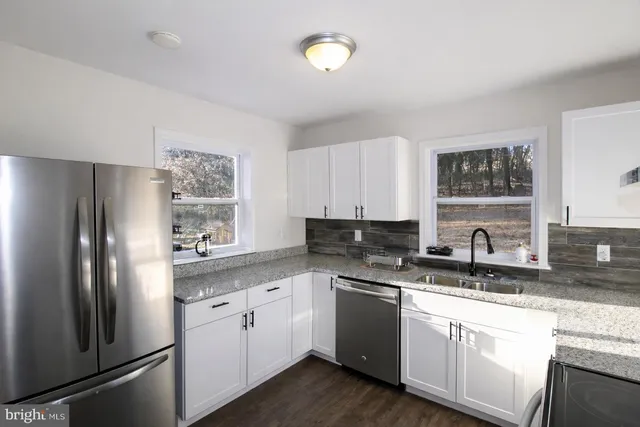 a kitchen with a refrigerator and a sink