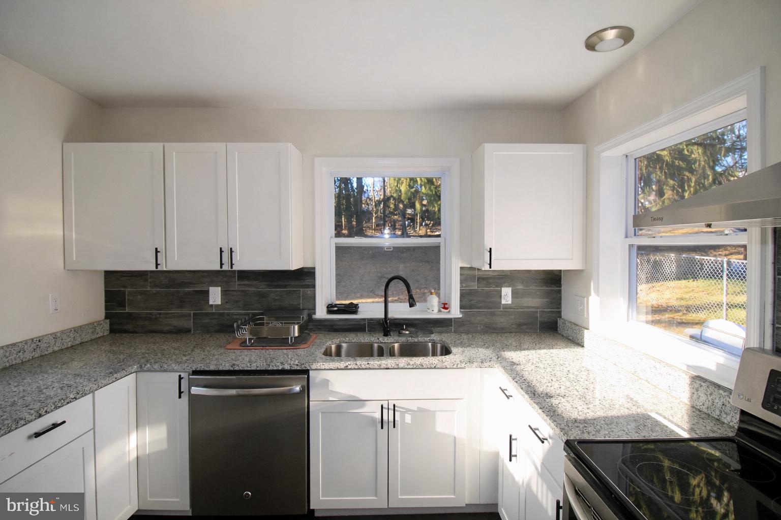 416 North Duke Street Hummelstown, PA 17036 - Photo 9 of 26 a kitchen with granite countertop a stove a sink and a refrigerator