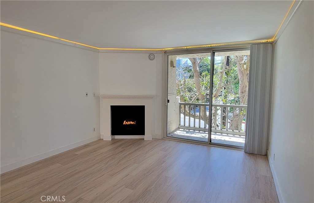 8740 Tuscany Avenue Playa del Rey, CA 90293 - Photo 4 of 21 a view of an empty room with wooden floor and a window