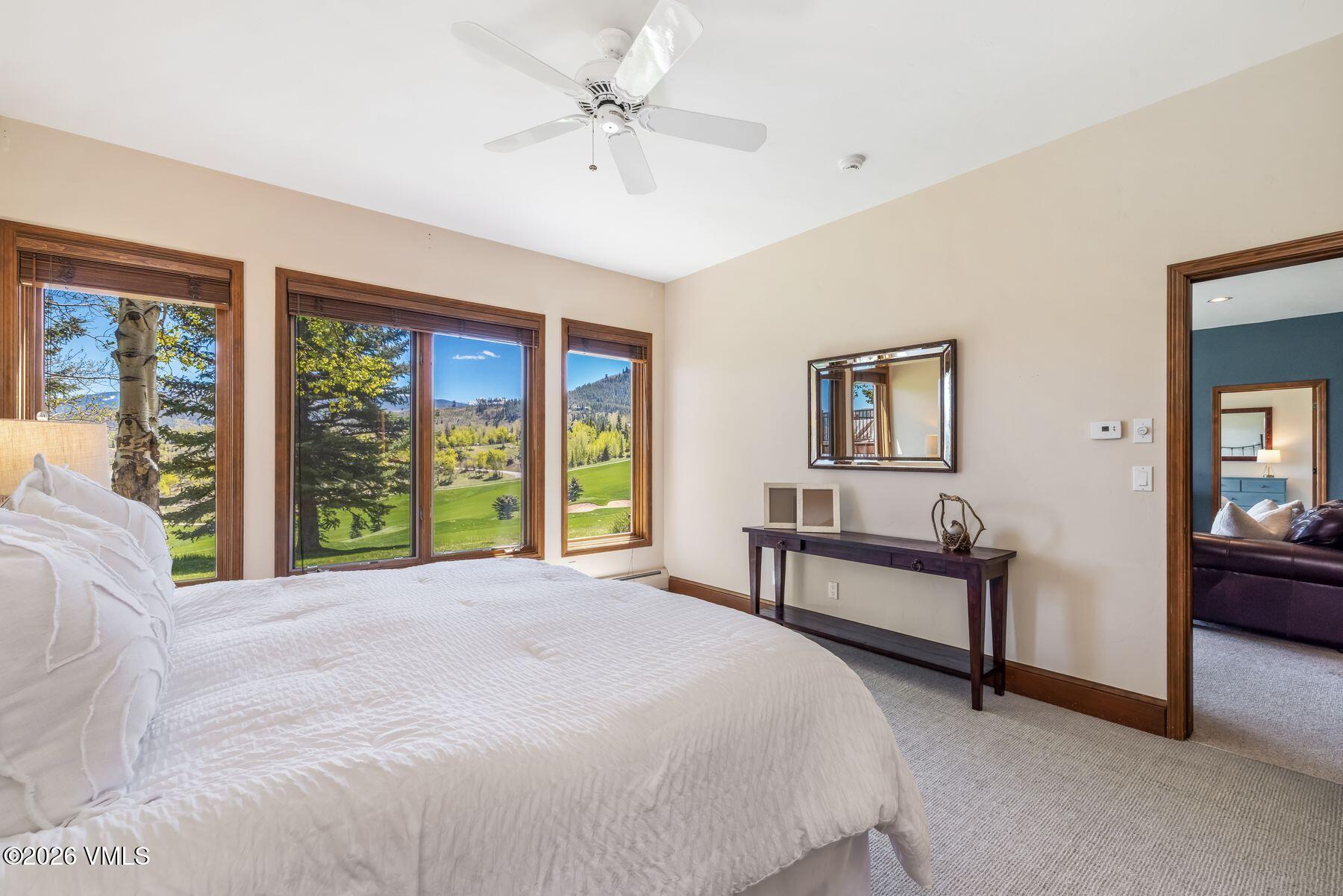 167 Saddle Ridge Edwards, CO 81632 - Photo 23 of 41 a spacious bedroom with a large bed and a chandelier