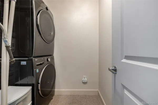 a bathroom with a washing machine and a mirror