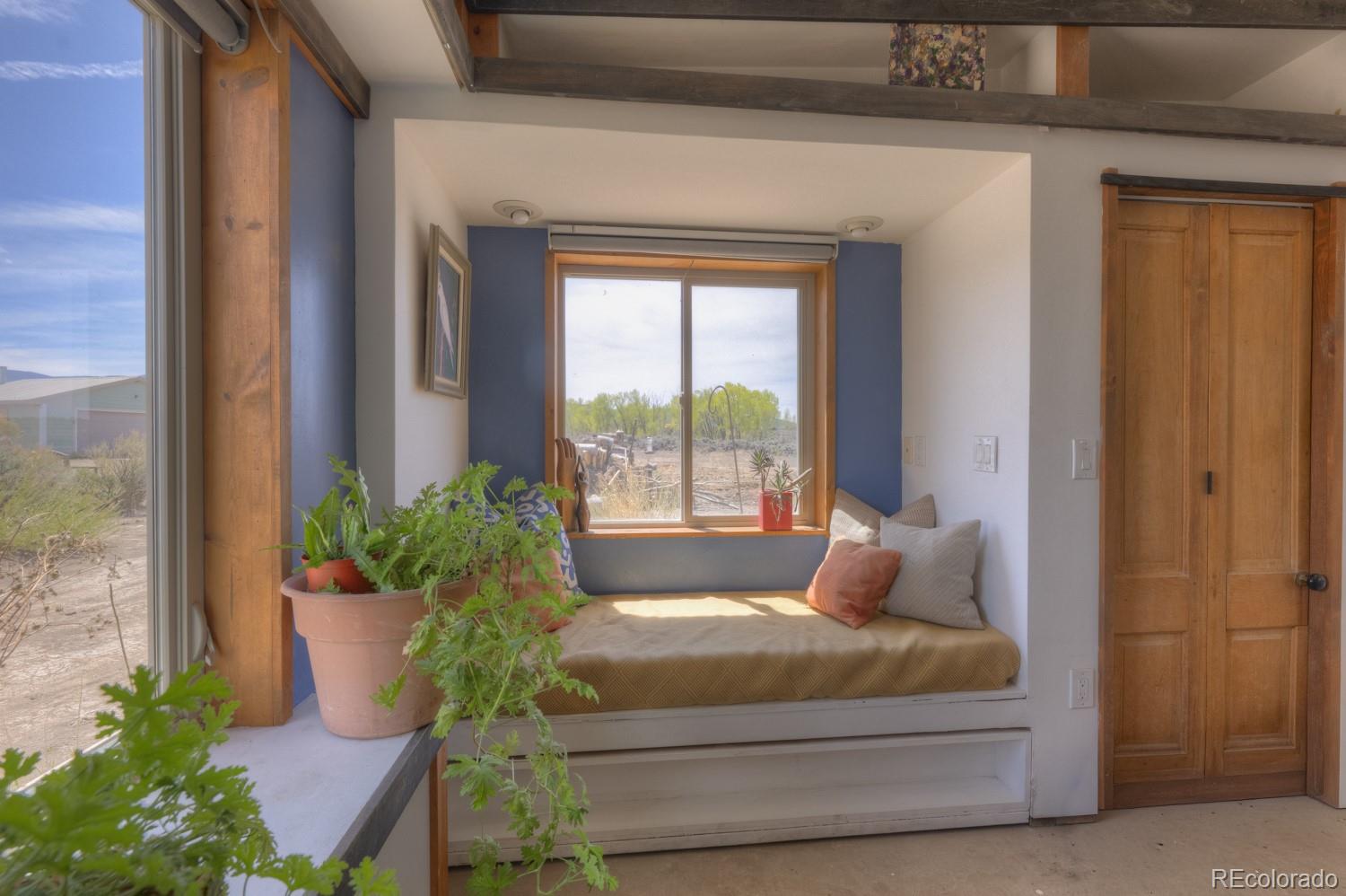 6592 Slegers Road Fort Garland, CO 81133 - Photo 11 of 30 a bedroom with a bed and a potted plant