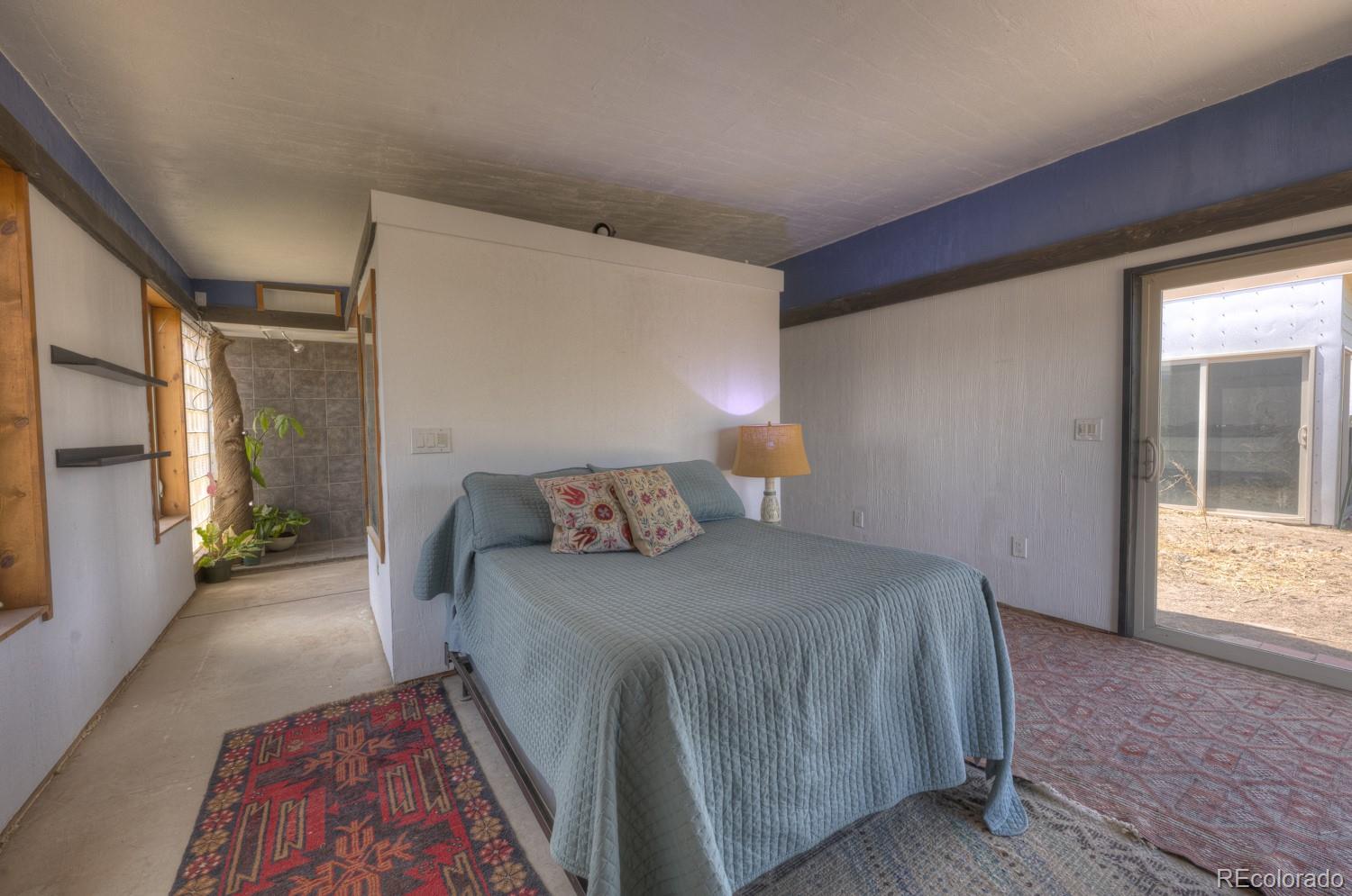 6592 Slegers Road Fort Garland, CO 81133 - Photo 16 of 30 a bedroom with a bed and a window