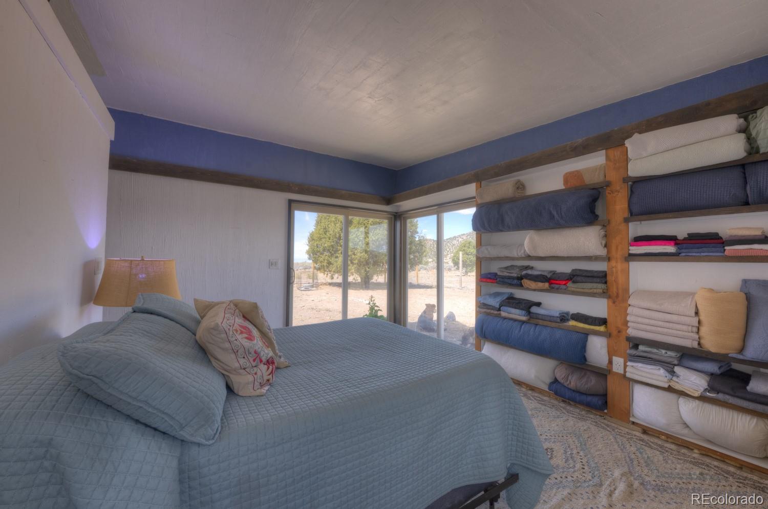 6592 Slegers Road Fort Garland, CO 81133 - Photo 17 of 30 a bedroom with a bed and a window