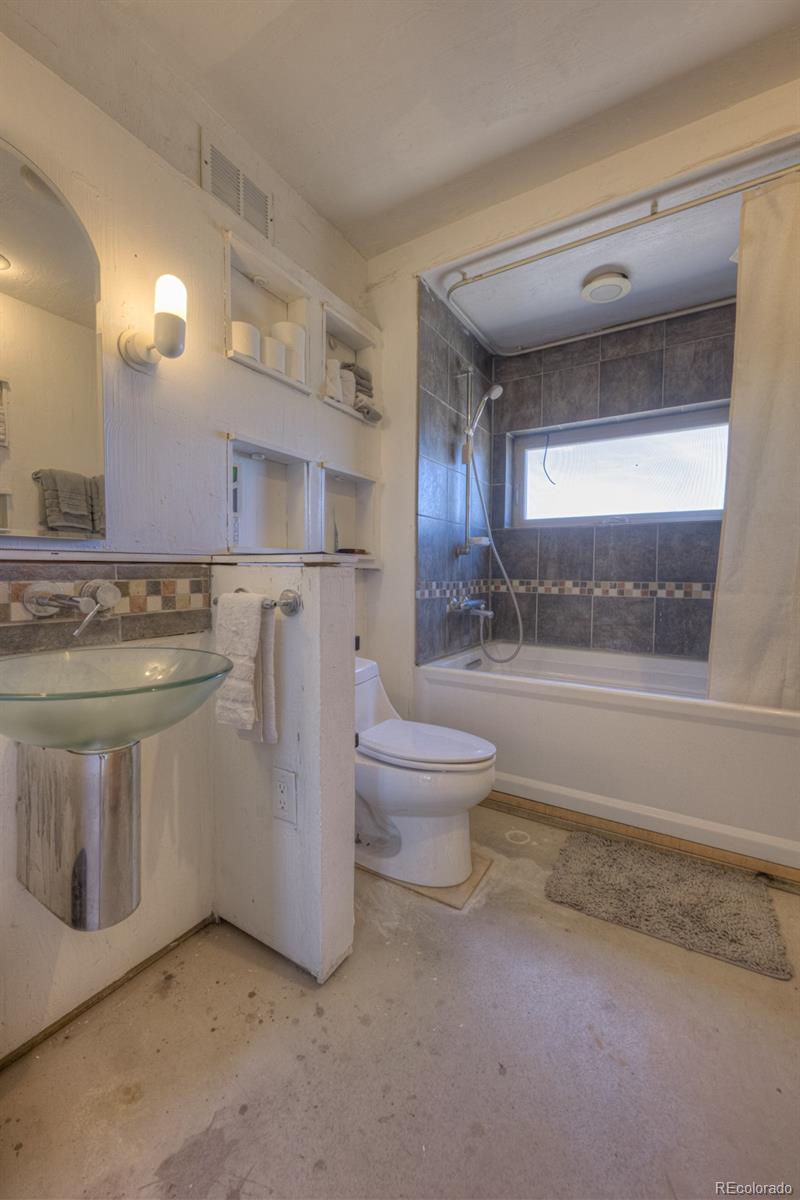 6592 Slegers Road Fort Garland, CO 81133 - Photo 18 of 30 a bathroom with a toilet a sink and a window