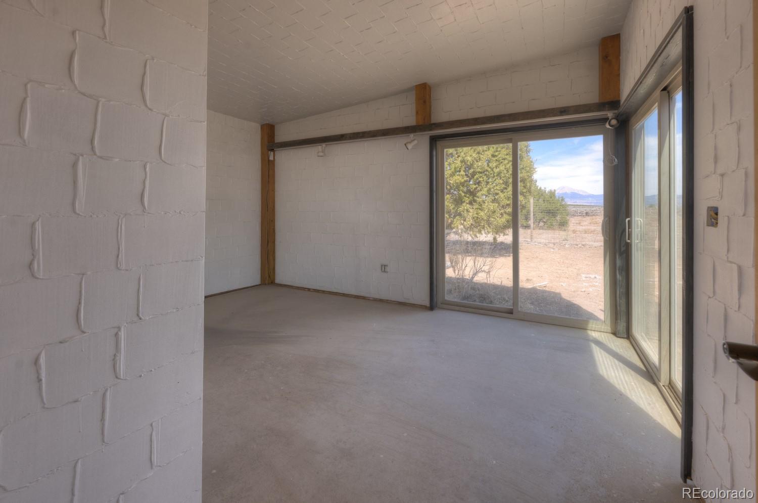 6592 Slegers Road Fort Garland, CO 81133 - Photo 20 of 30 a view of empty room with floor to ceiling window