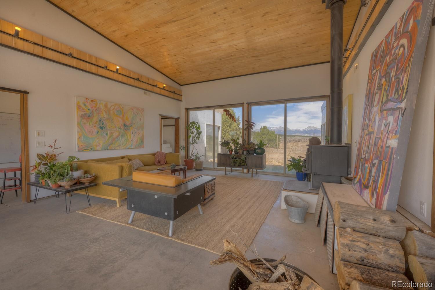 6592 Slegers Road Fort Garland, CO 81133 - Photo 3 of 30 a living room with furniture and a floor to ceiling window
