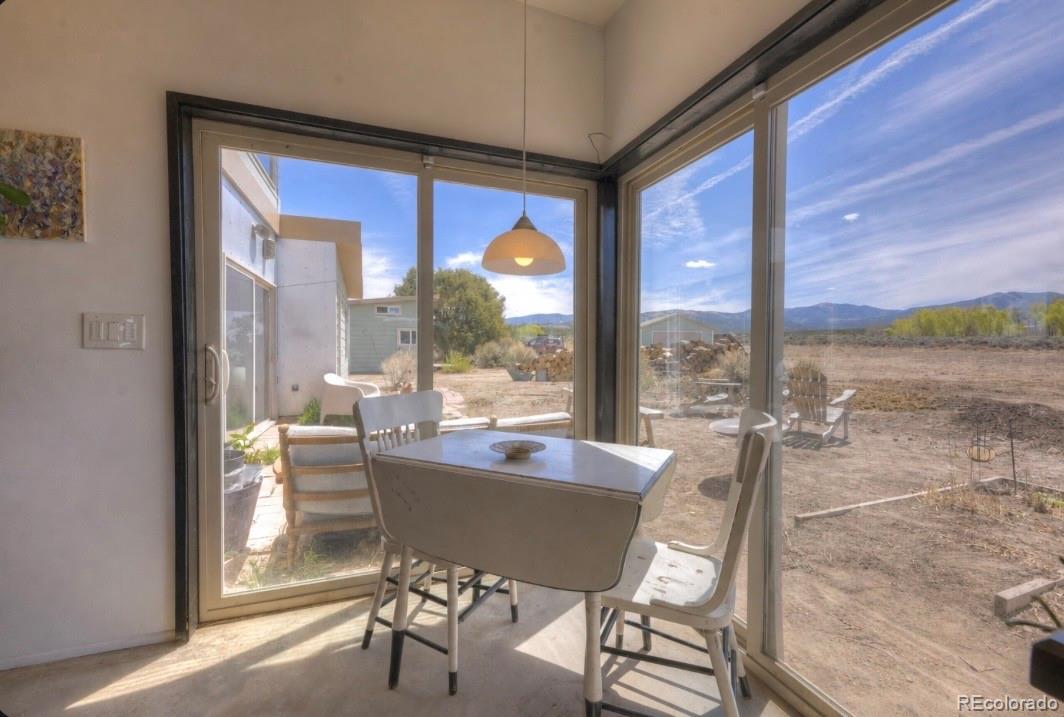 6592 Slegers Road Fort Garland, CO 81133 - Photo 6 of 30 a dining room with furniture and a floor to ceiling window