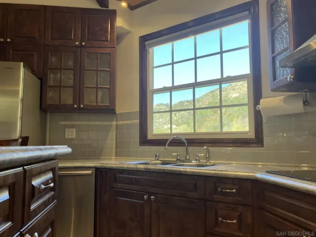 a kitchen with a sink cabinets and a window
