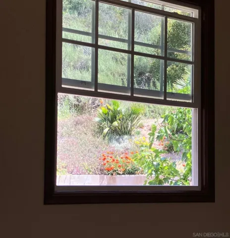 a bathroom with a tub a sink and a window
