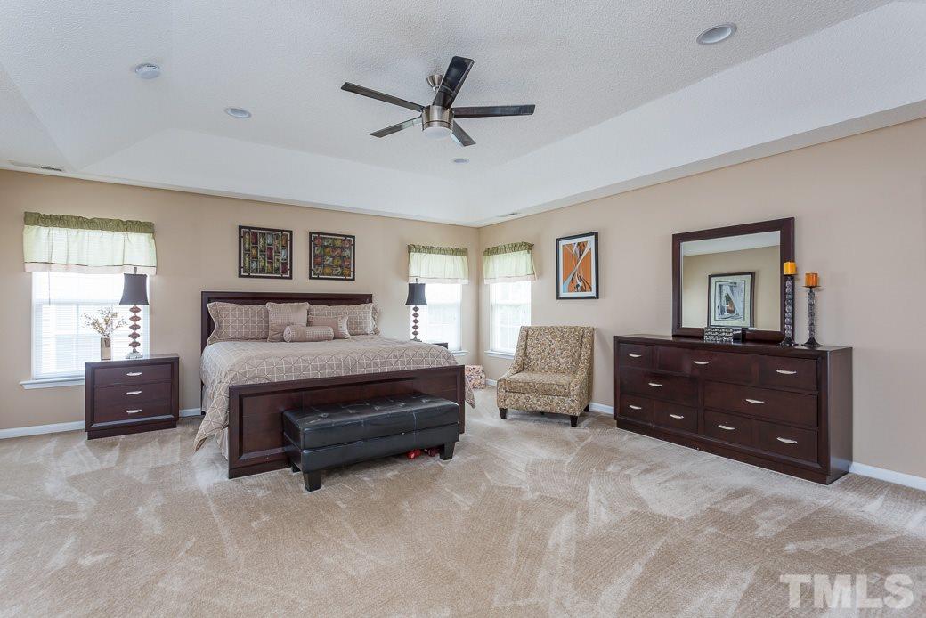 5716 Sea Fox Court Raleigh, NC 27616 - Photo 12 of 23 a bedroom with a bed and a dresser