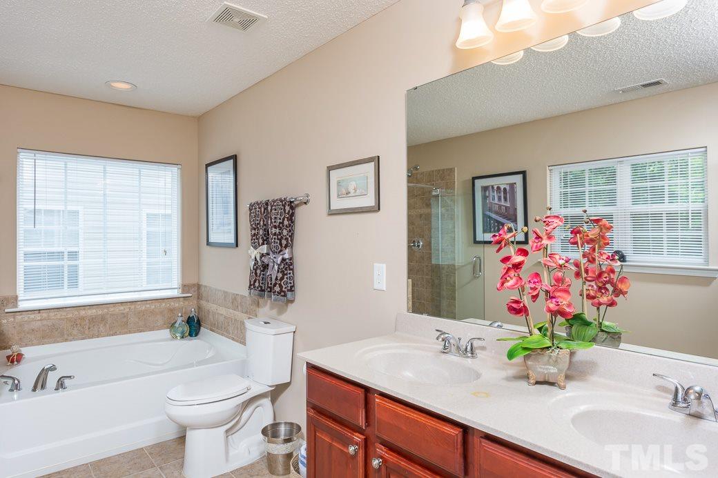 5716 Sea Fox Court Raleigh, NC 27616 - Photo 13 of 23 a bathroom with a granite countertop sink and a mirror