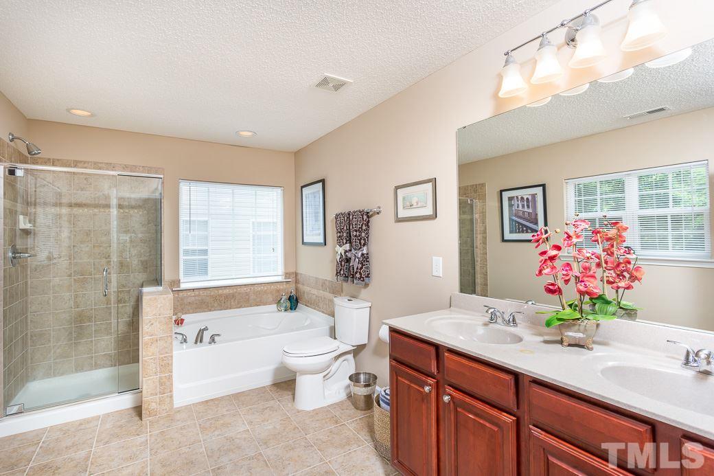 5716 Sea Fox Court Raleigh, NC 27616 - Photo 14 of 23 a spacious bathroom with a tub sink mirror and a shower
