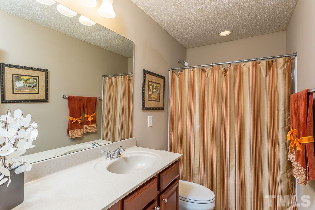 5716 Sea Fox Court Raleigh, NC 27616 - Photo 18 of 23 a bathroom with a sink toilet and shower