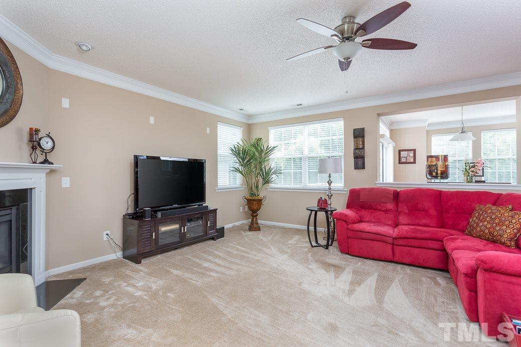 5716 Sea Fox Court Raleigh, NC 27616 - Photo 9 of 23 a living room with furniture and a flat screen tv