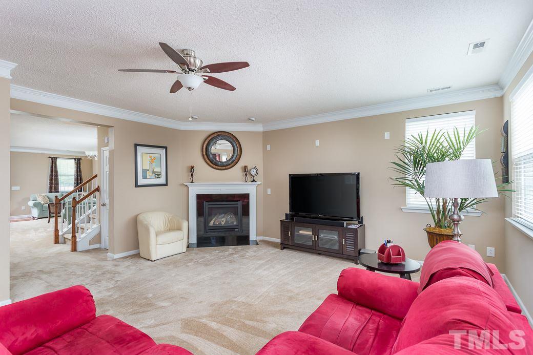 5716 Sea Fox Court Raleigh, NC 27616 - Photo 10 of 23 a living room with furniture and a flat screen tv