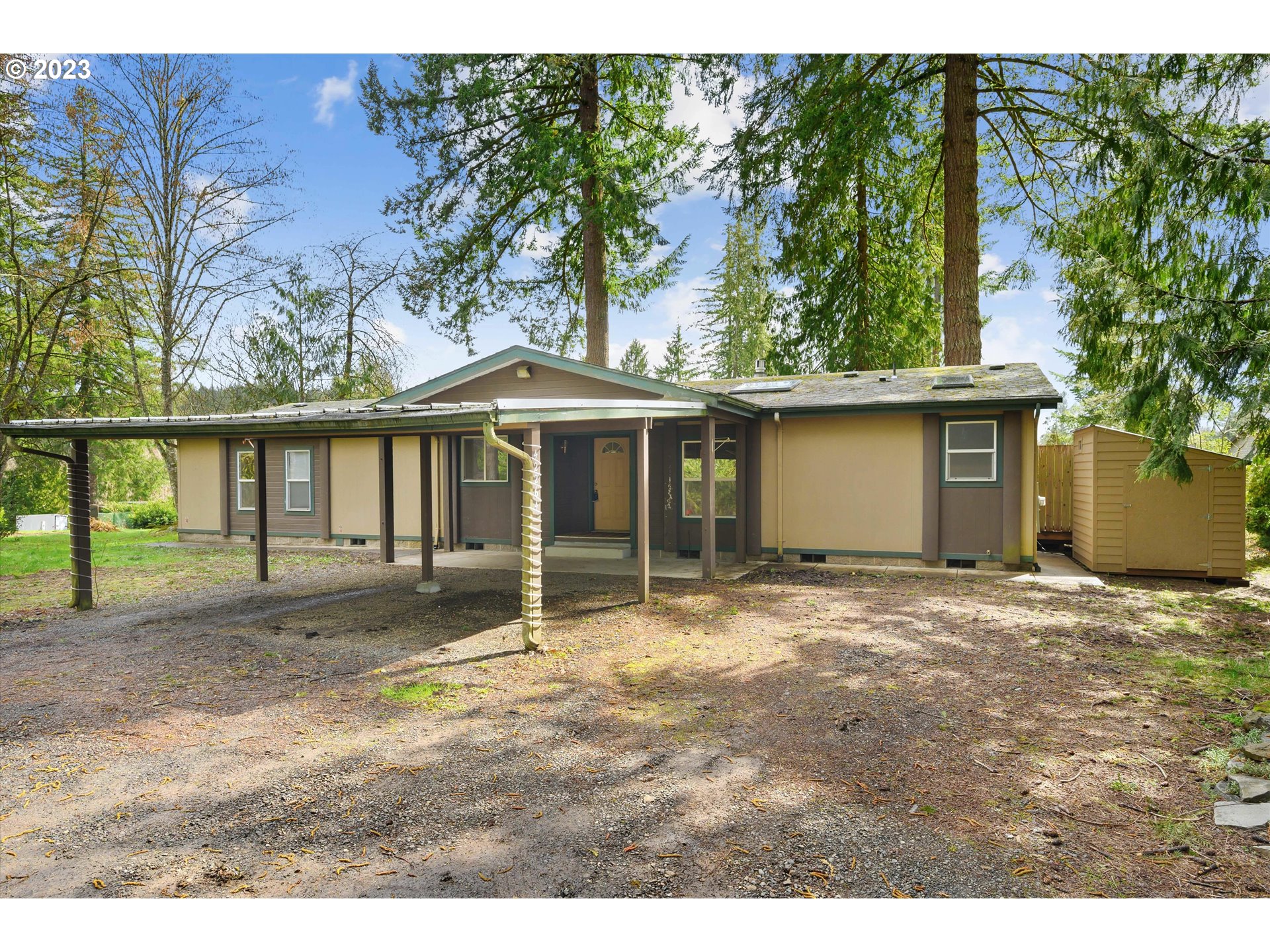 a view of a house with a yard and sitting area