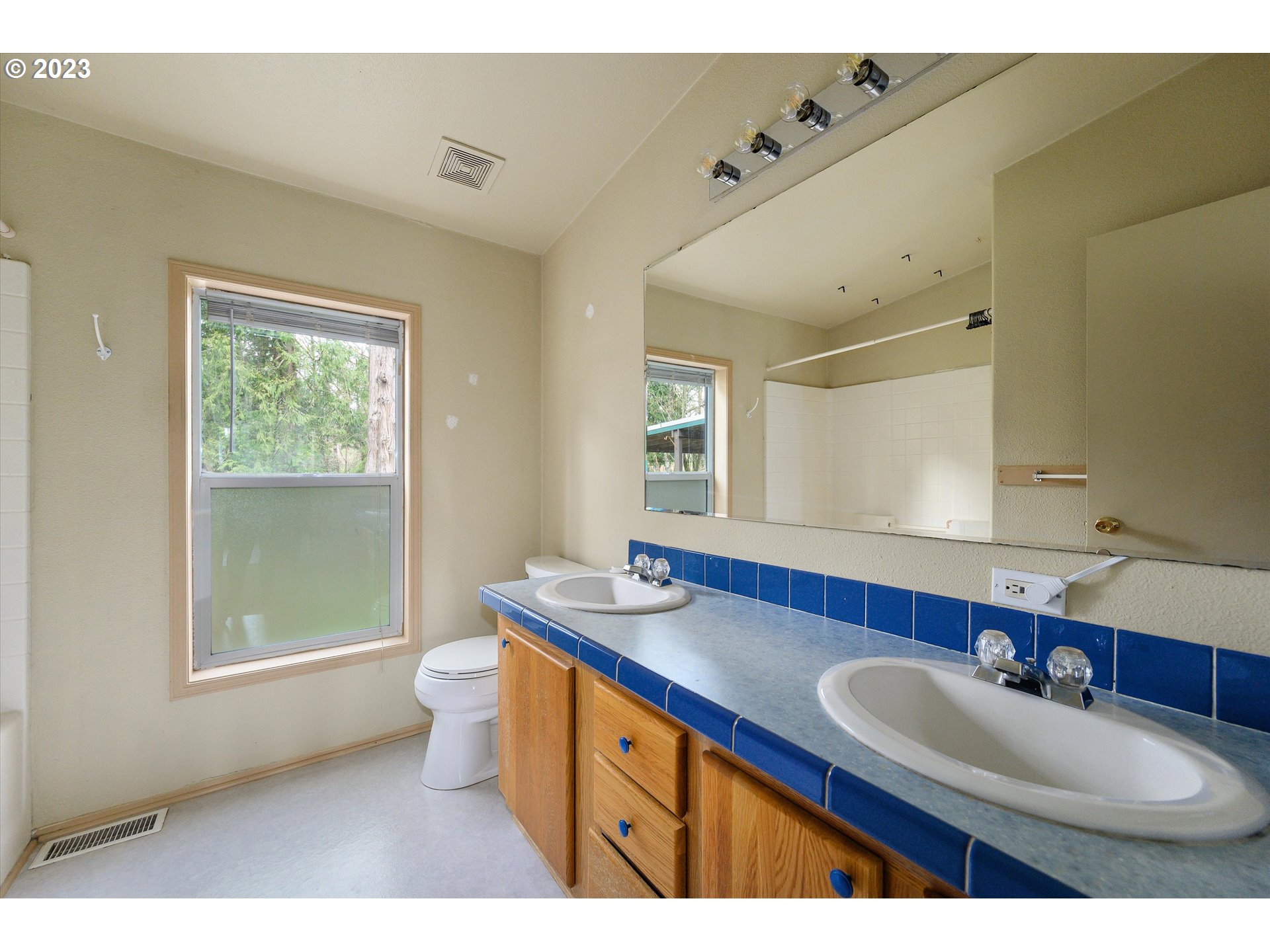 42264 Southeast Locksmith Lane Sandy, OR 97055 - Photo 21 of 36 a bathroom with a sink double vanity granite and a toilet
