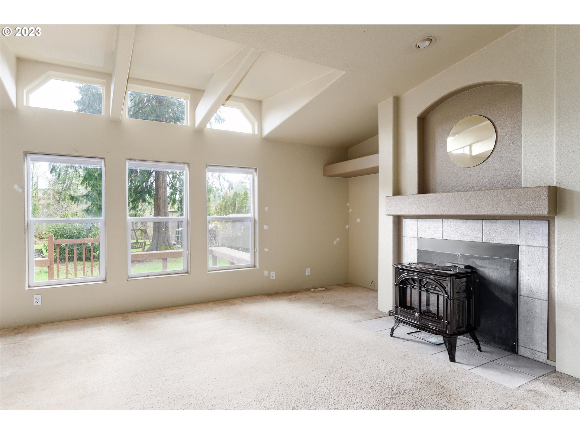 42264 Southeast Locksmith Lane Sandy, OR 97055 - Photo 3 of 36 a view of an empty room with a fireplace and a window