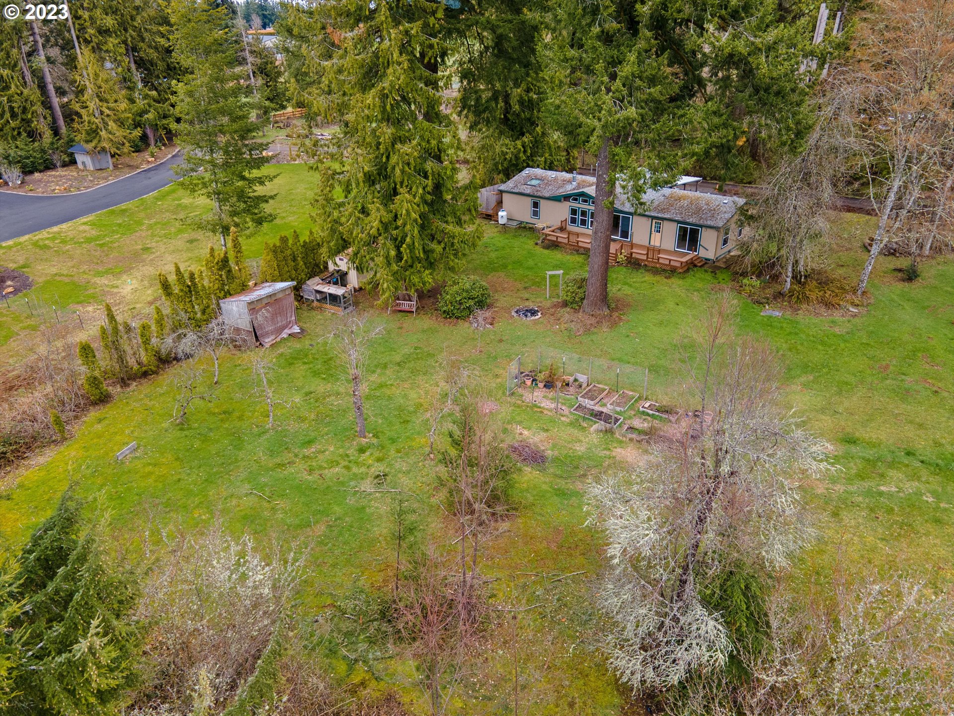 42264 Southeast Locksmith Lane Sandy, OR 97055 - Photo 32 of 36 a backyard of a house with table and chairs